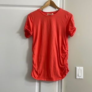 Michael by Michael Kors orange short sleeves top with gold zippers.